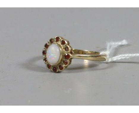 A ladies 9ct gold ruby and opal cluster ring, UK size R. 2.45 grms.