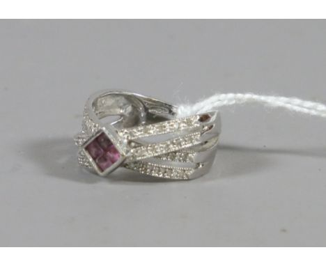 A ladies 9 carat white gold diamond and amethyst crossover ring, 4.40 grams.