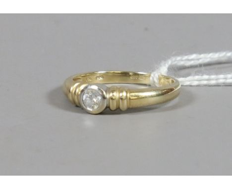 A ladies 14ct gold and solitaire gem set dress ring, UK size L.5. 2.51 grams.