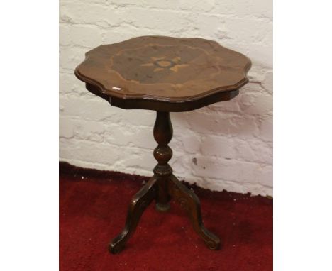 An inlaid mahogany tripod wine table.