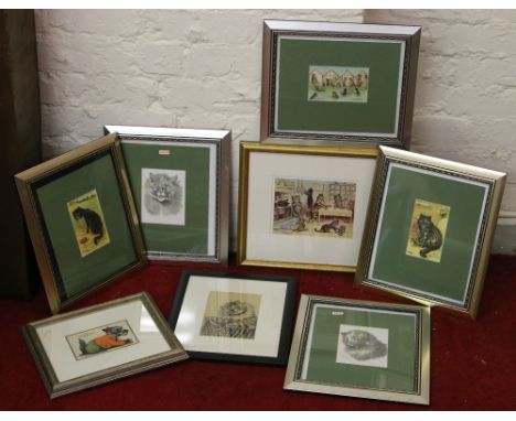 A collection of framed Louis Wain prints.