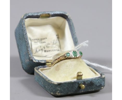 A 9ct gold ring set with emeralds and diamonds size M1/2.