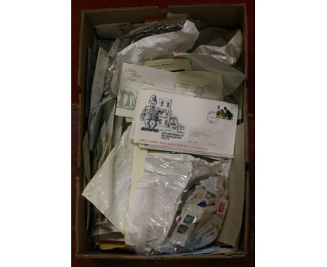 A box of assorted stamps from around the world along with First Day Covers.