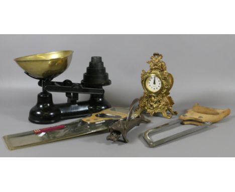 A set of cast and brass kitchen scales and graduated weights along with a painted metal mantel clock, two saws and a novelty 