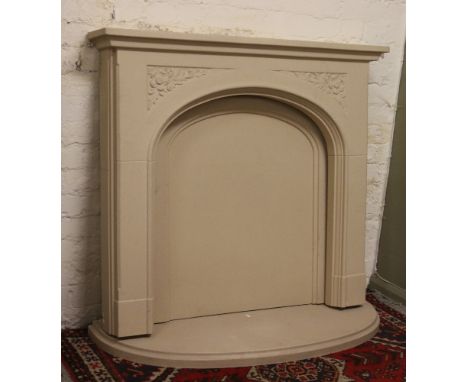 A decorative moulded stoneware fire surround, hearth and back.