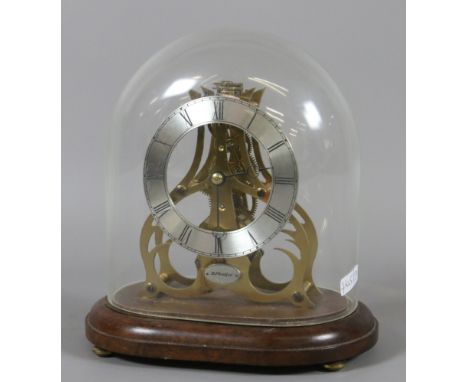 A small brass skeleton clock under glass dome with platform escapement and silvered chapter ring signed K J Bradford.