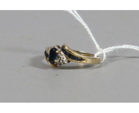 A ladies 9ct gold sapphire and diamond set crossover ring, UK size O.5. 2.33 grams.