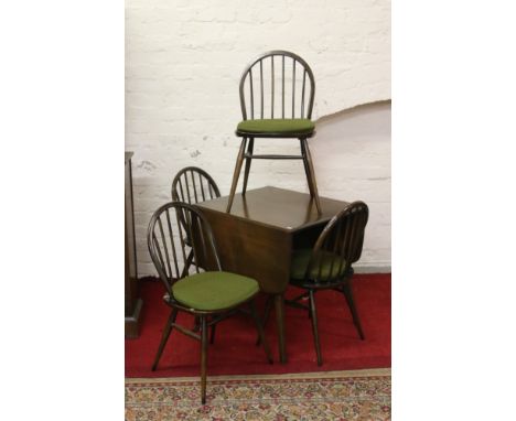 An Ercol dropleaf dining table along with a set of four Ercol spindleback dining chairs.