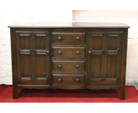 An Ercol panelled oak two door sideboard.