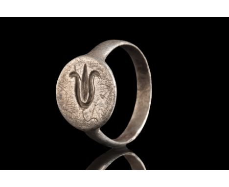 Ca. 1100-1400 AD.A silver finger ring of elegant simplicity boasts a flat-section hoop that encircles the finger with an unde