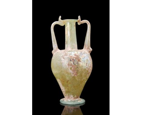 Ca. 200 AD.A glass amphoriskos, an exemplar of artistic finesse, exhibits a captivating inverted piriform contour, with a dis