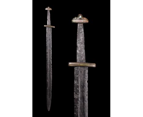 Ca. 900-1000 AD.An iron forged sword featuring a broad blade with parallel edges, tapering to a sharp point, ideal for pierci