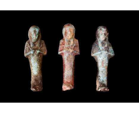 Late Period, 30th Dynasty, Ca. 332 BC.A group of three ushabtis, fashioned from the light blue glazed composition. These smal