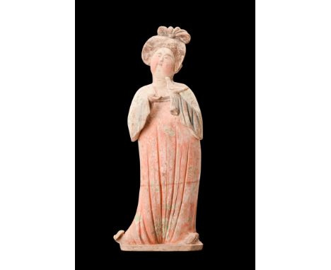 Ca. 618-907 AD. A ceramic figure known as the 'Fat Lady.' Crafted with meticulous attention to detail, this figure stands wit