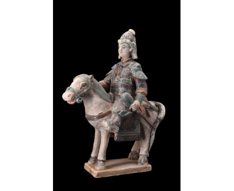 Ca. 1368-1644 AD, or later.A pottery mingqi, portraying a horse and a valiant warrior rider adorning its back. The sculpture 