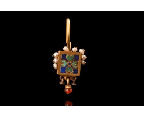 Ca. 800 AD.A stunning gold earring with a central square-shaped plaque, which is the focal point of the piece. It is adorned 