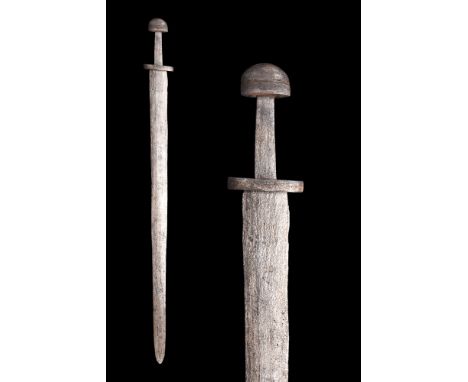 Ca. 900-1000 AD.An iron sword In excavated condition, with a broad double-edged blade, the hilt comprising thick ovoidal cros