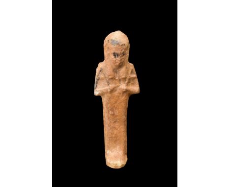 Late Period to Ptolemaic Period, ca. 664-30 BC.This ushabti of its characteristic mummiform style stands atop a petite and fl