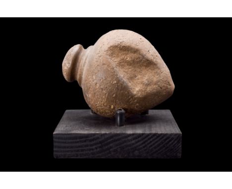 Ca. 800-1000 AD.A ceramic hollow vessel, with its distinctive acorn-shaped body, raised mouth, and domed rim. The vessel's sm