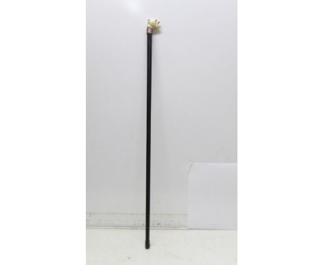 A swagger stick with carved dogs head top, some a/f on dogs head 