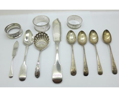 A collection of silver including a George IV silver spreader and two napkin rings, etc., a plated napkin ring and a plated si