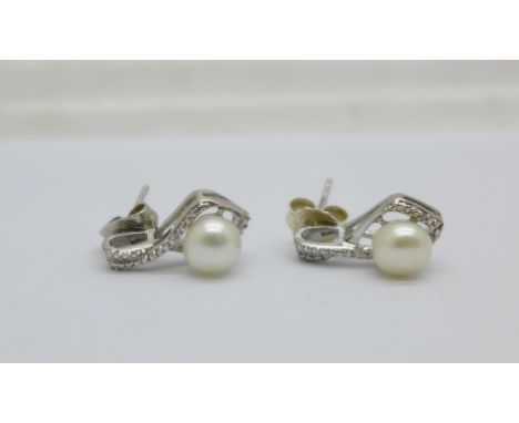 A pair of silver, diamond and pearl earrings 