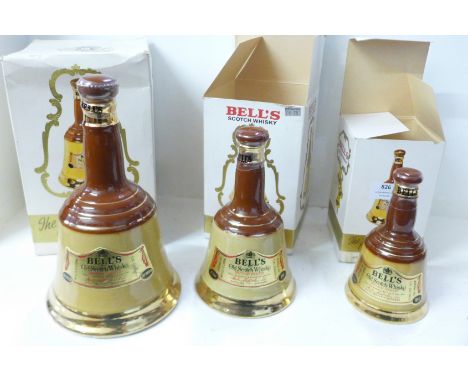 Three graduated Bell's Scotch Whisky bottles with contents 