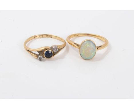 Gold (18ct) oval opal cabochon ring and gold (18ct) sapphire and diamond three stone crossover ring, both size N