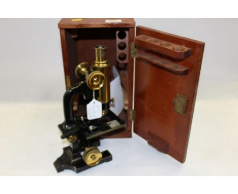 Swift Metallurgical microscope on black enamel stand, with single objective and eyepiece, fine and coarse focus adjustment an