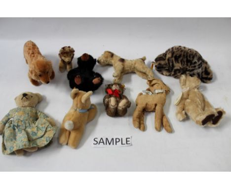 A selection of small soft toys including Steiff green eyed tiger cub with button in ear, Teddy 029271, Rabbit 5658/16, Tabby 