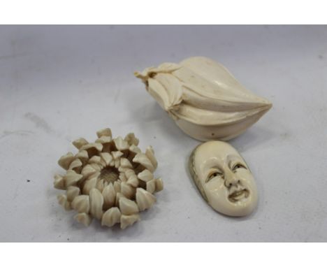 Meiji period Japanese carved ivory netsuke in the form of a chrysanthmum bloom, 5cm wide, together with another carved as a n