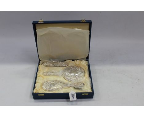 Contemporary silver mounted four piece dressing table set, comprising two brushes, hand mirror and comb in a fitted case (Bir