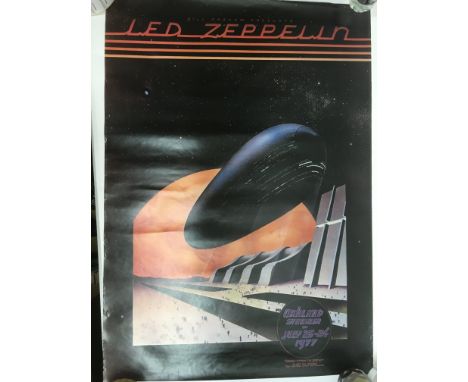 A box of various music posters, artists include Led Zeppelin, U2, The Rolling Stones and others.