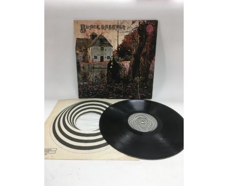 A first UK pressing of Black Sabbath's debut LP complete with Vertigo poly lined inner sleeve, a Philips record product text 