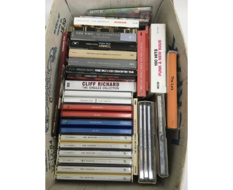 A collection of CD box sets by various artists including The Beatles, The Who, Noel Gallagher, Dead Kennedys and others.