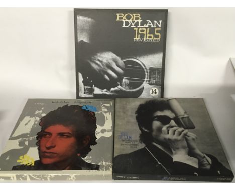 Three Bob Dylan CD box sets comprising '1965 Revisited', 'The Bootleg Series' and 'Biograph'.