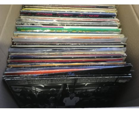 A box of LPs and 12 inch singles by various artists including The Rolling Stones, Fleetwood Mac, Pet Shop Boys and others.