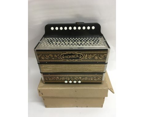 A boxed Hohner accordion.