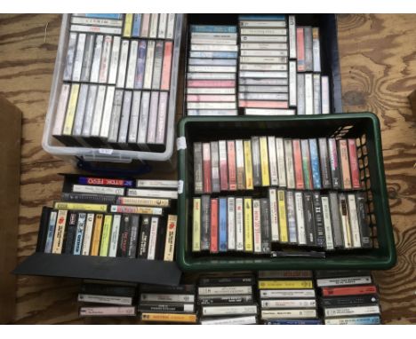 A collection of cassettes by various artists including Eric Clapton, The Rolling Stones, David Bowie, The Who and others.