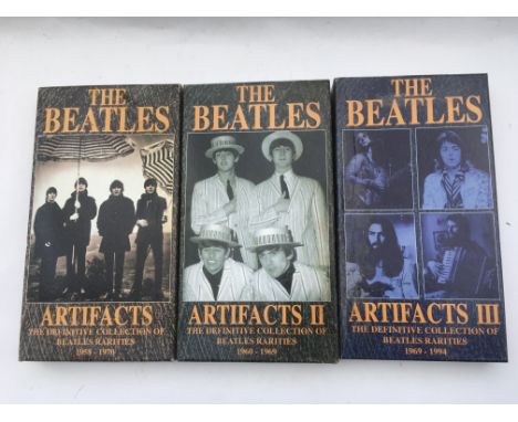 Three Beatles 'Artifacts' long box CD sets, some water damage.