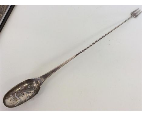 An unusual Continental silver pickle fork / pierced spoon with twisted stem. Approx. 26 cms long. Est. £25 - £35.