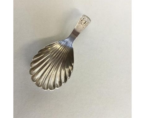 A Georgian silver caddy spoon with fluted bowl. London. By EM. Approx. 8 grams. Est. £30 - £50.