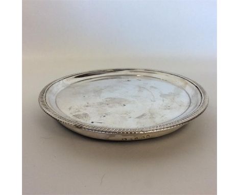 PAUL STORR: A good quality Georgian circular silver teapot stand with gadroon rim. London. Approx. 14 cms in diameter. Approx