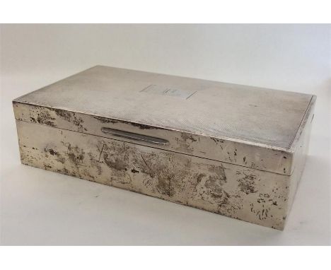 A rectangular engine turned silver cigarette case with domed top. Birmingham. By E&N. Approx. 432 grams. Est. £40 - £60.