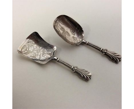 A Georgian bright cut caddy spoon decorated with flowers and scrolls. Birmingham. By GU. Together with one other. Approx. 16 