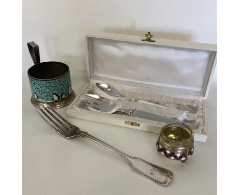 A Russian silver plated cup holder decorated with penguins together with a fork, an enamelled salt, and a Dixi christening sp
