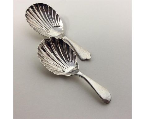 A heavy modern caddy spoon with fluted bowl and wavy silver handle together with one other. Approx. 32 grams. Est. £30 - £40.