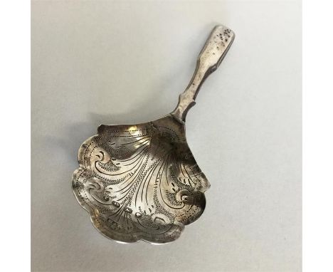 An early Georgian silver bright cut caddy spoon. Birmingham. By HB. Approx. 8 grams. Est. £30 - £50.