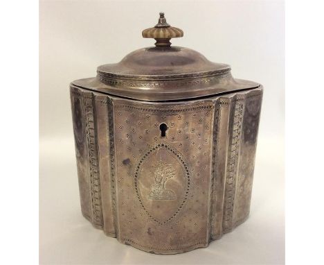 A good Georgian silver tea caddy, the body attractively decorated with wriggle work, crested front, hinged top and fitted int