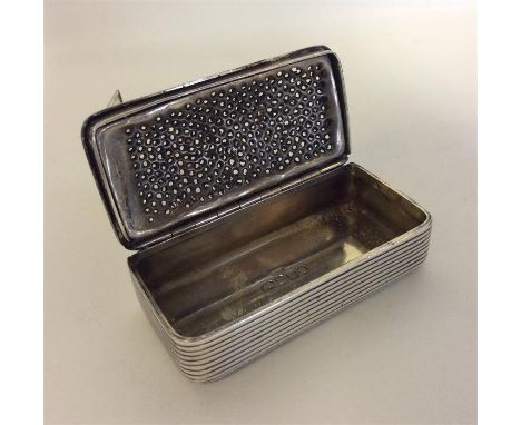 A large rare Georgian silver snuff box / nutmeg grater, the double hinged top revealing a grill and gilt interior. London. By